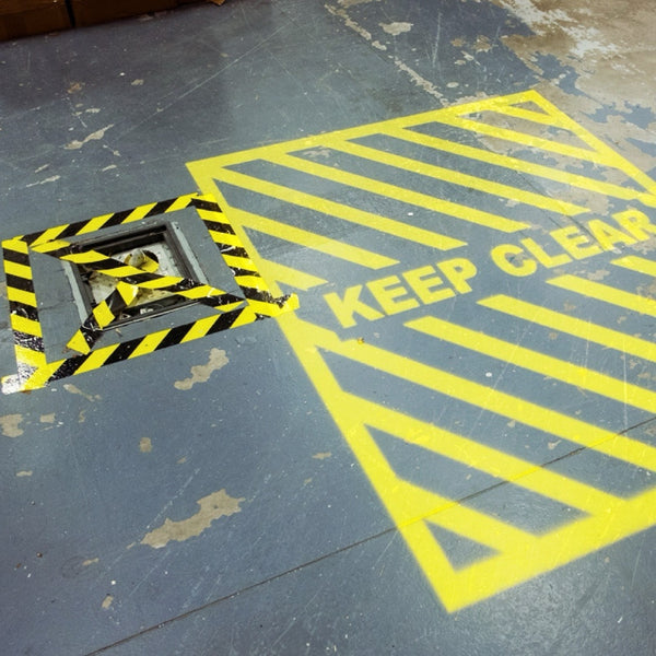 Projected floor safety markings of a keep clear zone and floor marking tape.